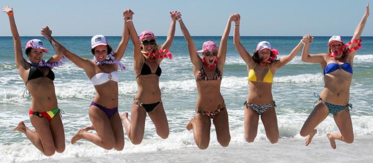 Spring breakers get airborne before the bikini parade in Panama City Beach.